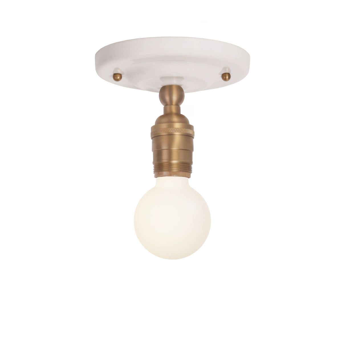 Grace Surface shown in Heirloom Brass with a Gloss White Ceramic canopy and no shade