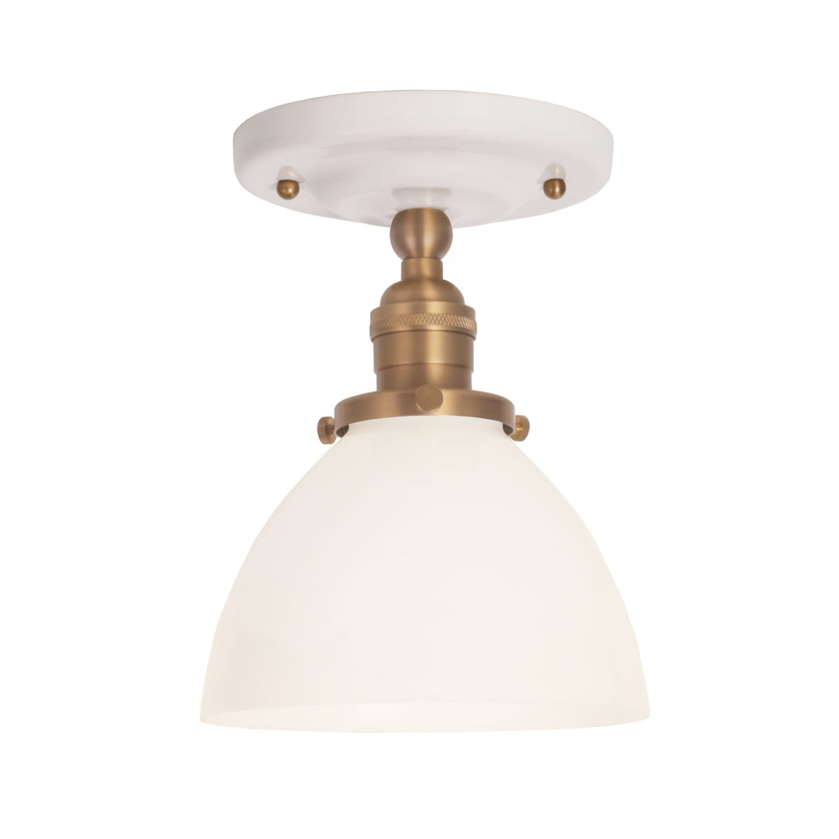 Grace Surface shown in Heirloom Brass with a Gloss White Ceramic canopy and an Opal Glass shade