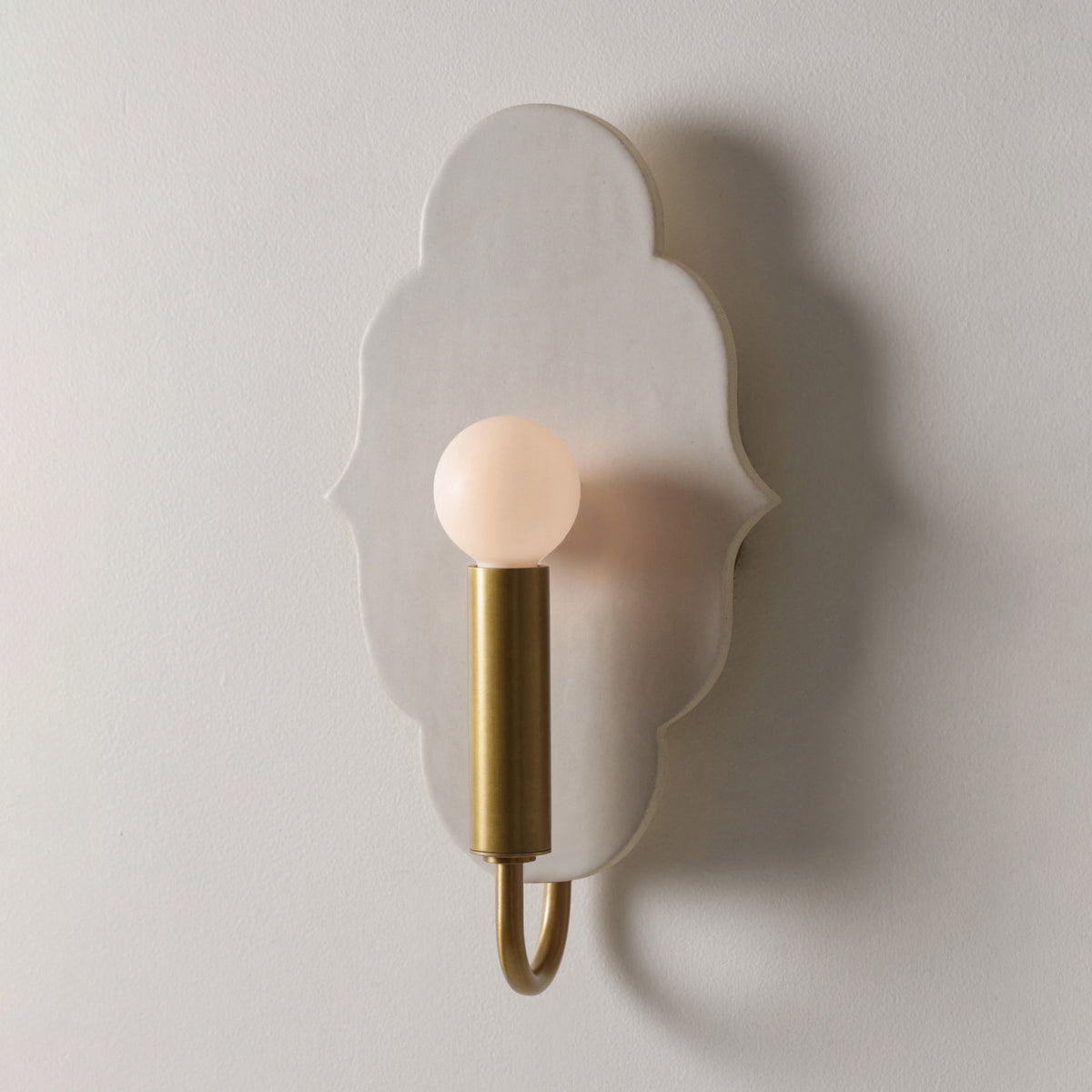 Clare Ceramic Sconce shown in Heirloom Brass with a Natural White Glaze