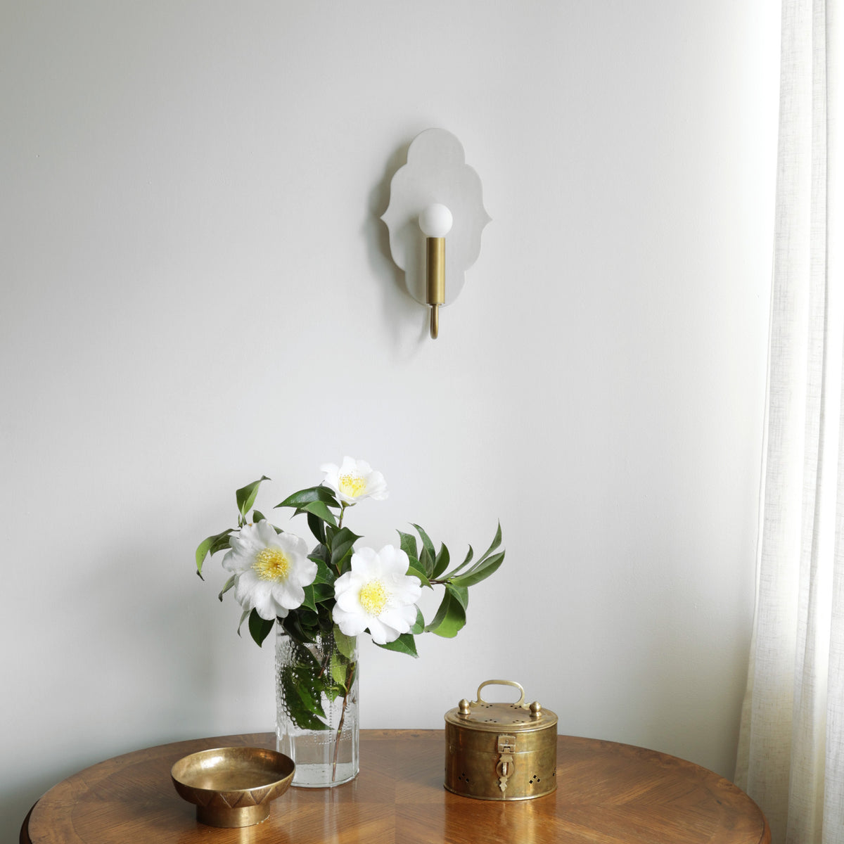 Clare Ceramic Sconce shown in Heirloom Brass with a Natural White Glaze