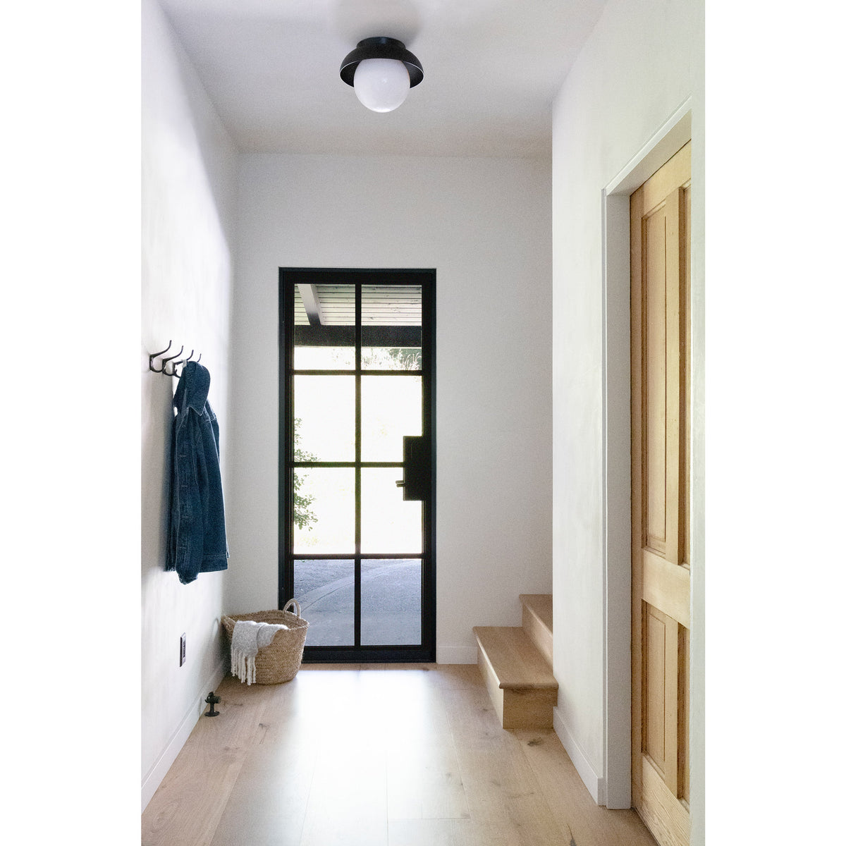 Lexi Large 8” shown with a Solid shade in Matte Black and Black Stained finish canopy
