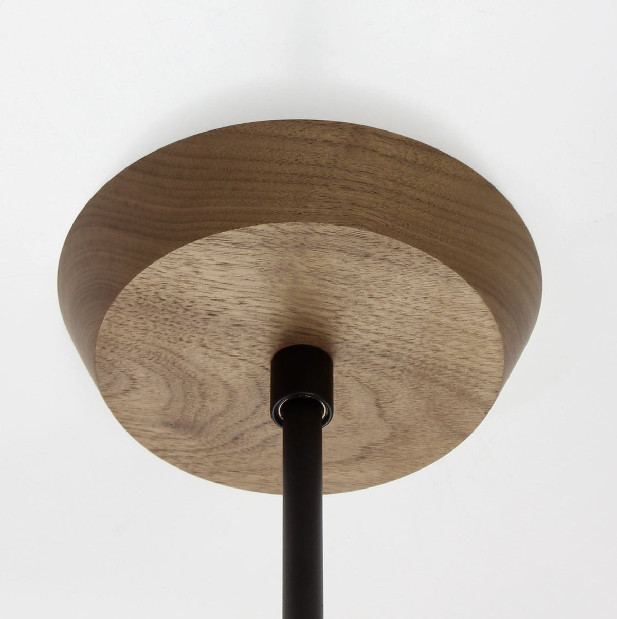 Mounting canopy shown in Walnut with Matte Black rod