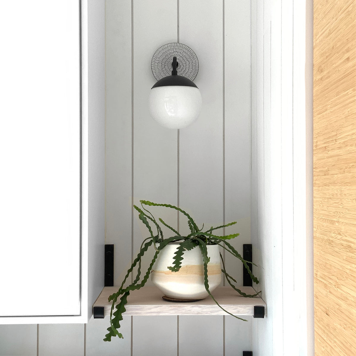 Alto Sconce 6" shown in Matte Black with a Brownstone White Sunflower Ceramic Canopy. Interior Design by Alison Vercruysse