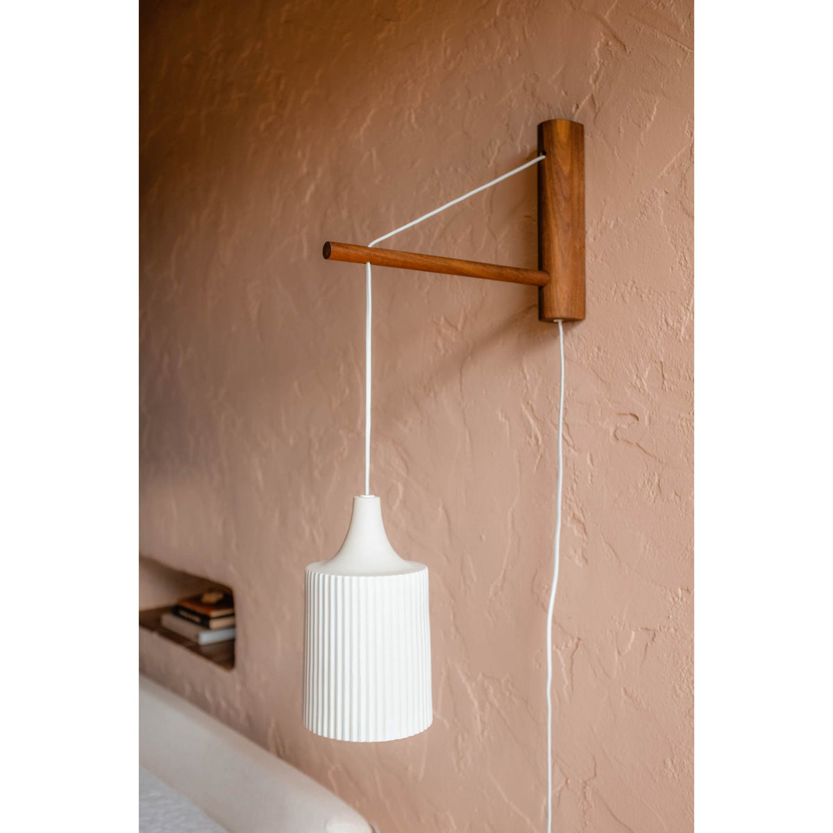 Tumwater 14" Wood Arm Sconce shown in Walnut with a White Plug-in Cord. Photo by Posada Inn by The Joshua Tree House