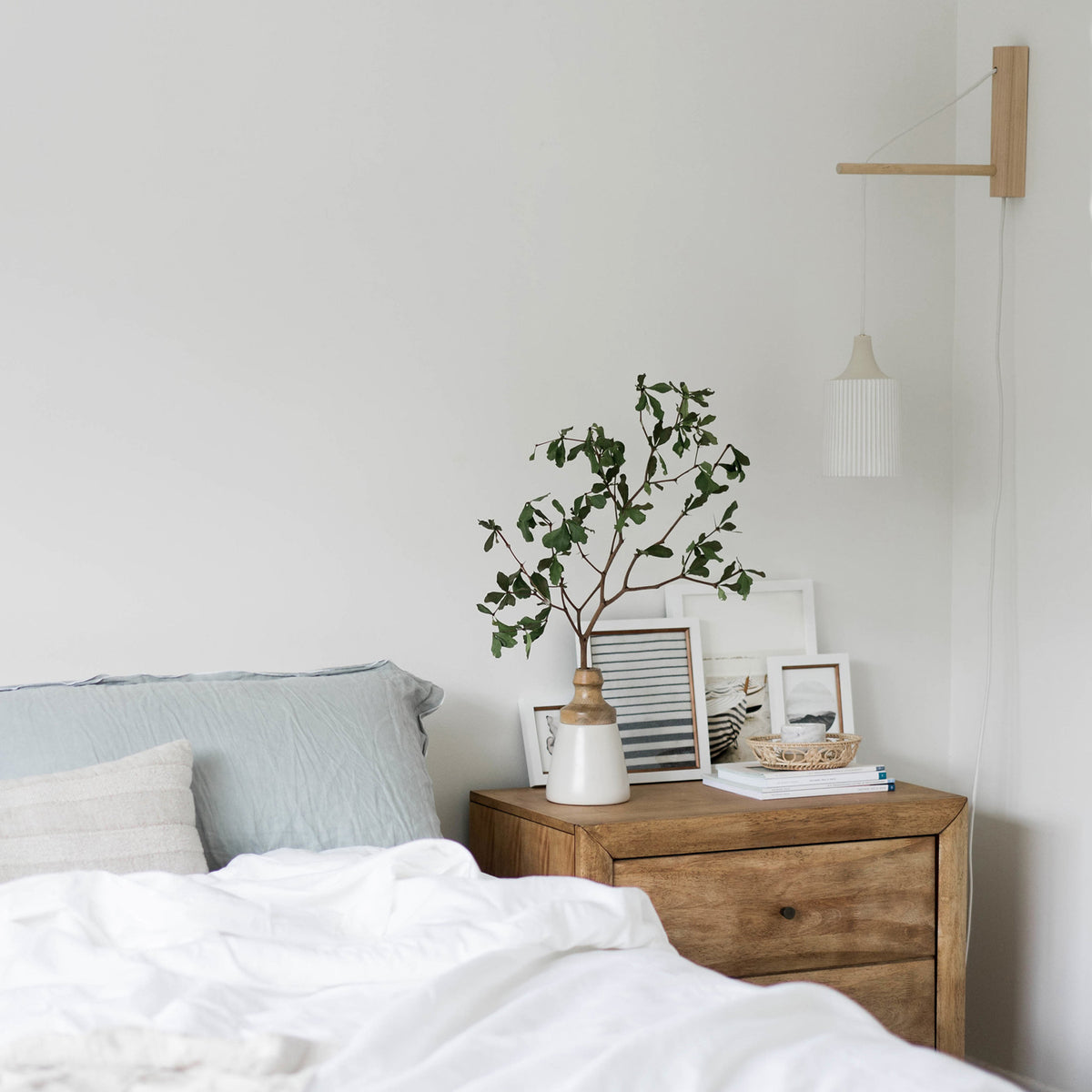 Tumwater 14" Wood Arm Sconce shown in Birch with a White Plug-in Cord. Interior Design by 41 Studios for Parachute Home. Photo by Belle + Whistle Studios.