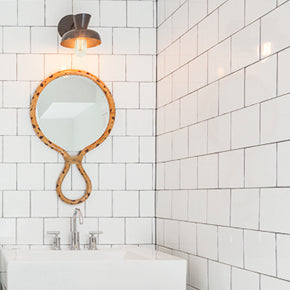 Isle Sconce shown in Matte Black. Interior Design by Teal Davison Design