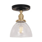 Grace Surface shown in Brass with a Gloss Black Ceramic canopy and Clear Glass shade