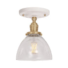 Grace Surface shown in Brass with a Gloss White Ceramic canopy and Clear Glass shade