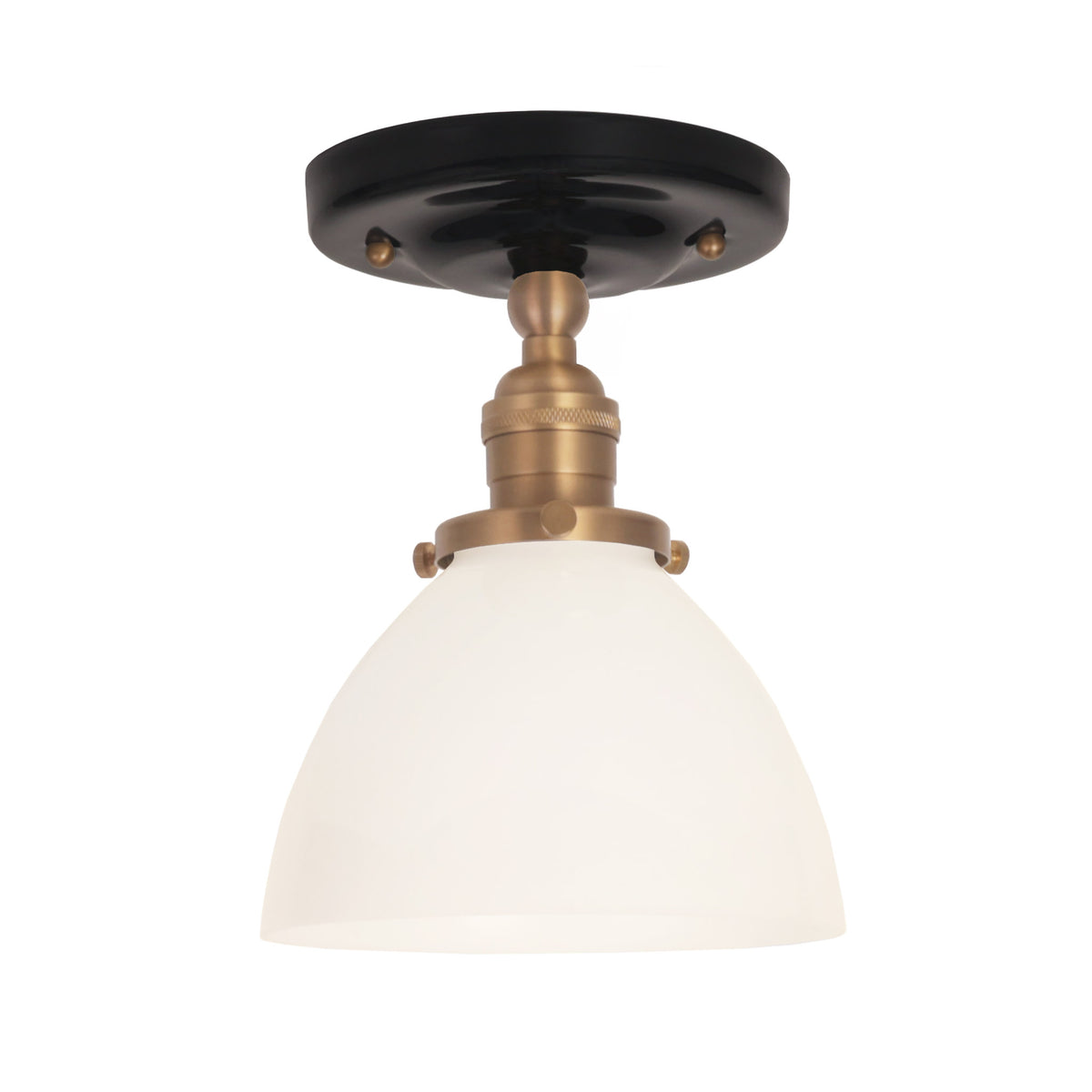 Grace Surface shown in Heirloom Brass with a Gloss Black Ceramic canopy and an Opal Glass shade