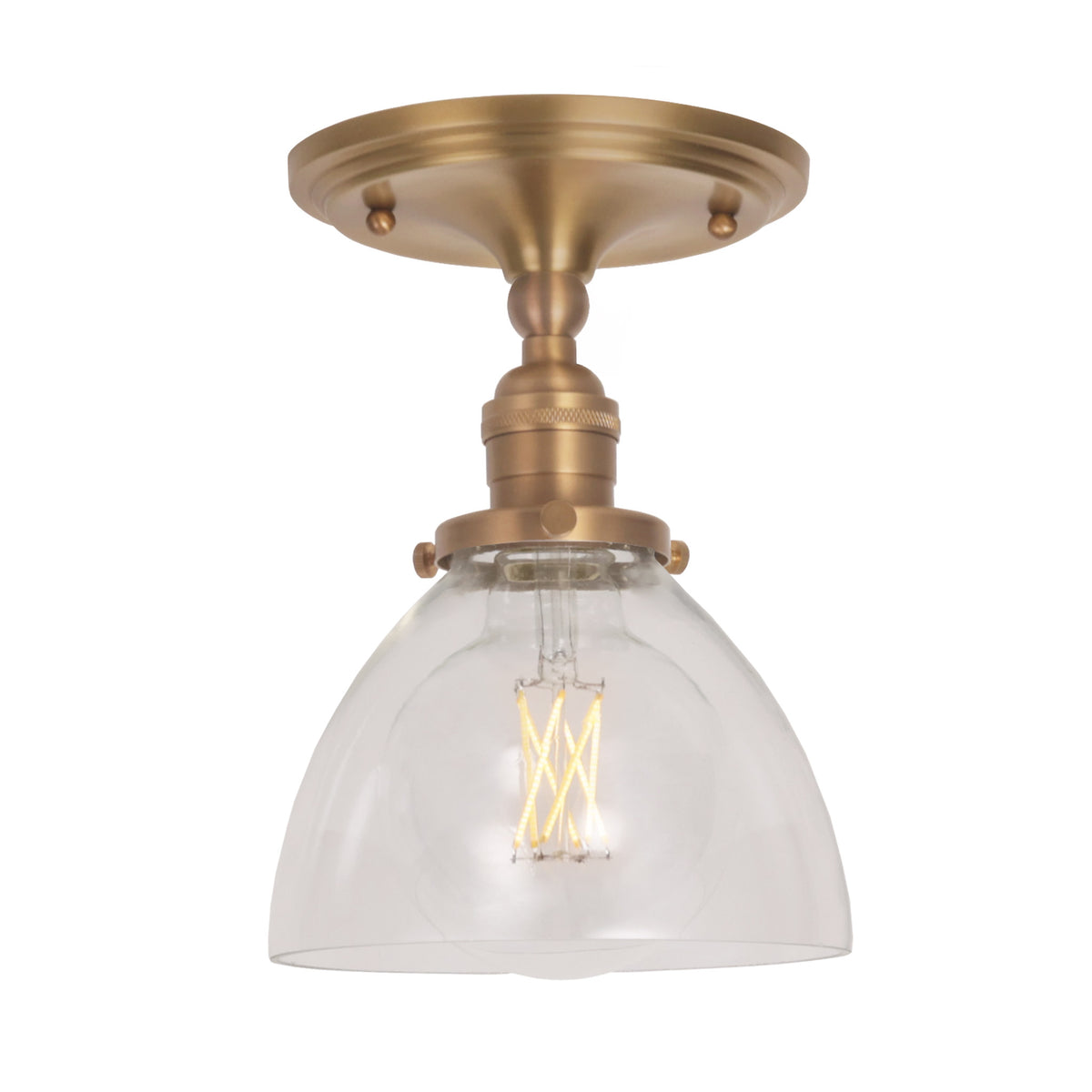 Grace Surface shown in Heirloom Brass with a Clear Glass shade