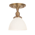 Grace Surface shown in Heirloom Brass with an Opal Glass shade