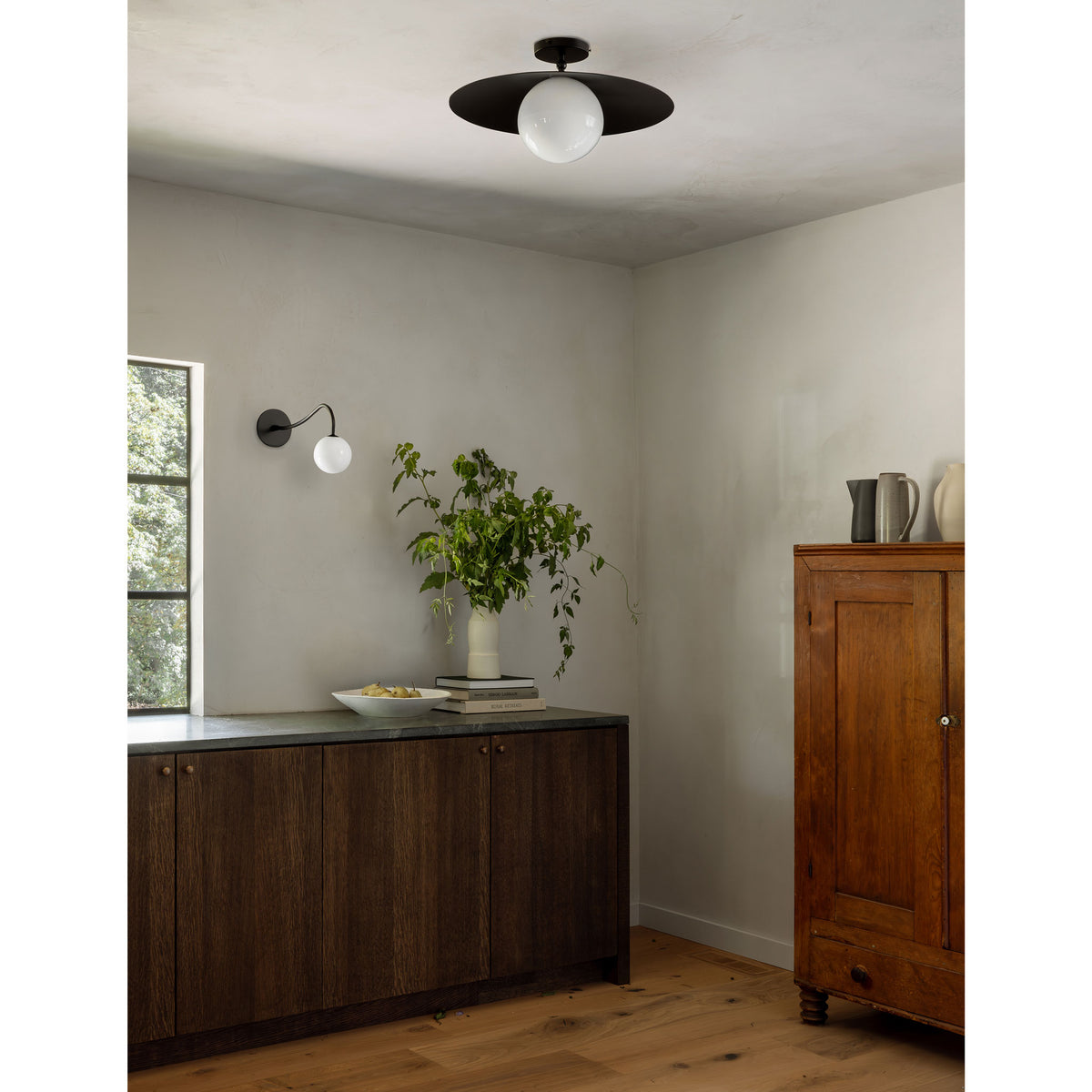 Marie Majeure Surface shown in Matte Black with a Josephine Wall Sconce
