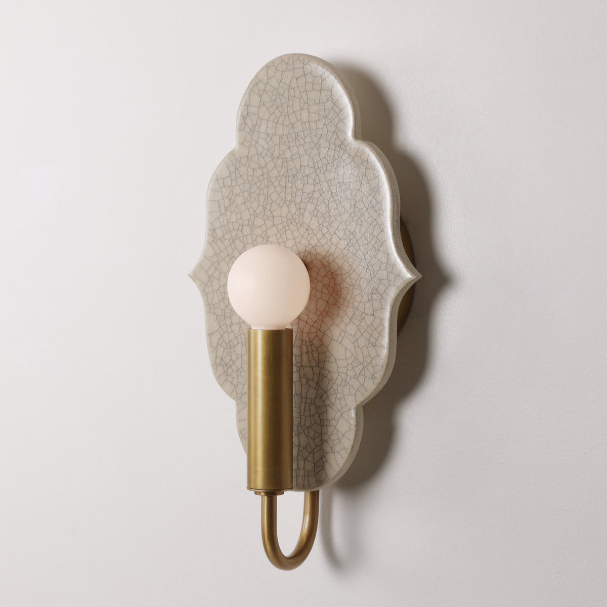 Clare Ceramic Sconce shown in Heirloom Brass with a Gloss Crackle Glaze 