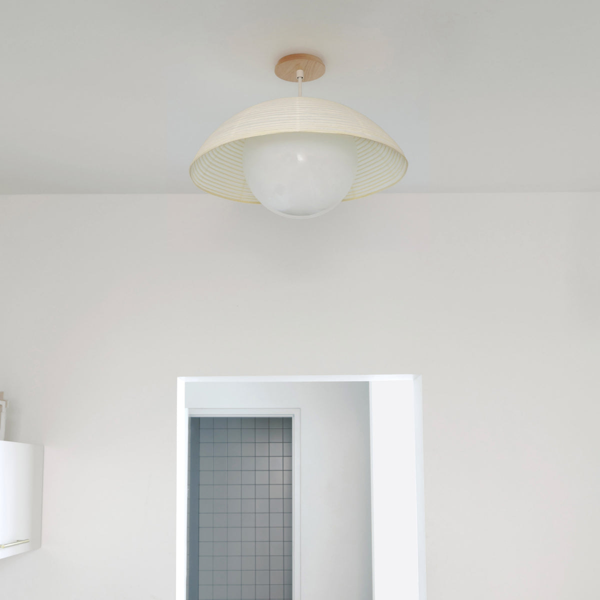 Maru Surface with a Natural shade shown in White with a Maple Wood canopy