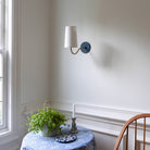 Genevieve Sconce shown in Heirloom Brass with an Ocean Blue canopy