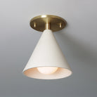 Petra Ceramic Surface shown in Heirloom Brass with a Tala Sphere II Bulb
