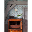 Edith ADA Sconce shown in Heirloom Brass with a Natural White and Cream Floral Ceramic Canopy