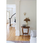 Edith ADA Sconce shown in Heirloom Brass with a Natural White and Cream Floral Ceramic Canopy