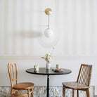 Ramona 8" Wall Sconce shown in Brass with an Opal 8" Glass Globe. Interior Design by Sarah Sherman Samuel