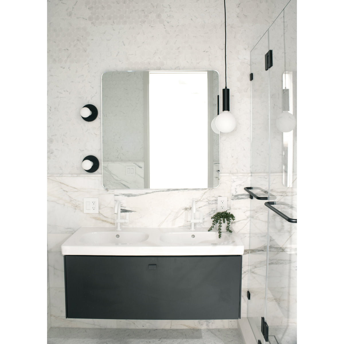 Fjord Cord Pendant shown in Matte Black with Black Cloth Cord. Swift Sconces shown in Matte Black