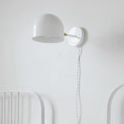 Amélie Sconce 8" shown in White with Brass with a White Twisted Cloth Cord. Interior Design by 41 Studios. Photo by Laura Palacios.