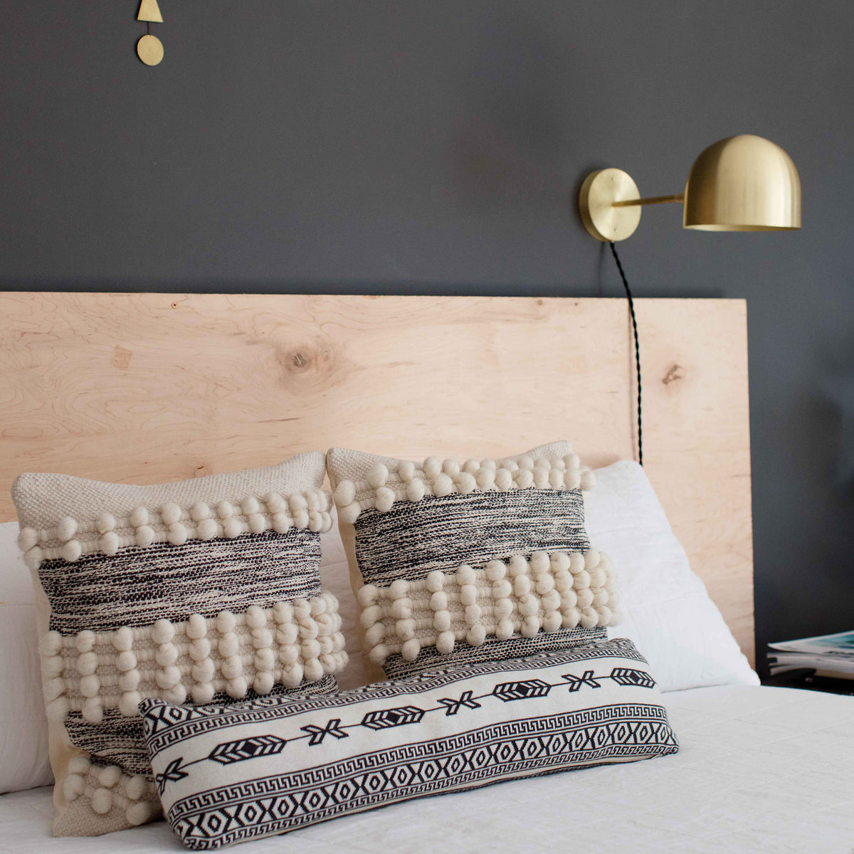 Amélie Sconce 8" shown in Brass with a Black Twisted Cloth Cord. Interior Design by Erin Barrett of Sunwoven. Photo by Margeret Wright.