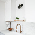 Tilt Cone shown in Matte Black and Brass with a 3" arm. Interior design by Field Theory Design. Photo by Ana Kamin