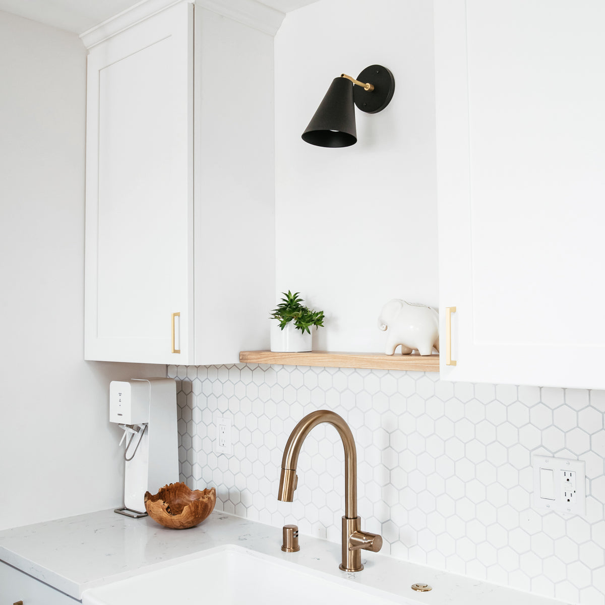 Tilt Cone shown in Matte Black and Brass with a 3" arm. Interior design by Field Theory Design. Photo by Ana Kamin