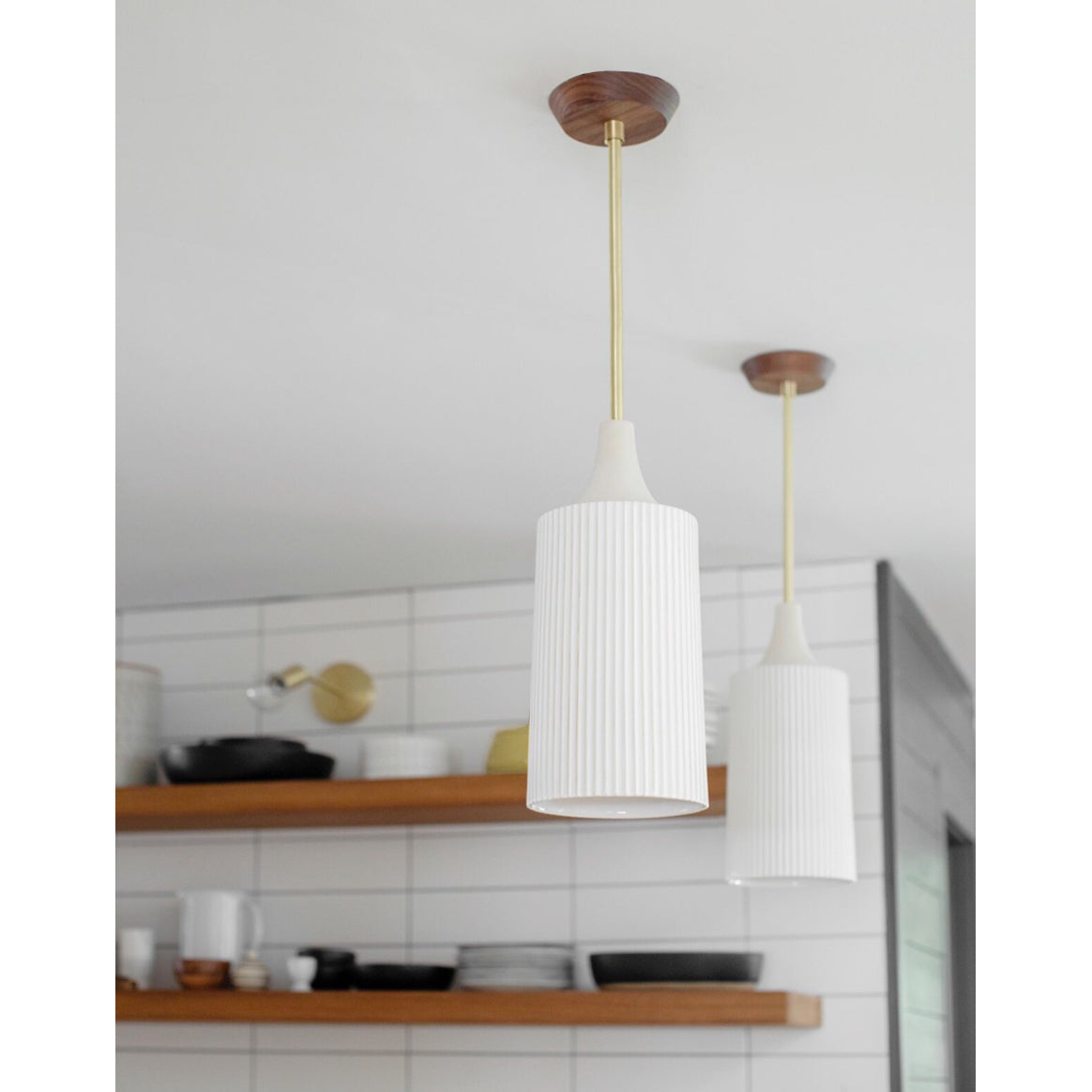 Tumwater Large Pendant shown in Brass with Walnut canopy. Interior design by Erin Barrett of Sunwoven. Photo by Margeret Wright